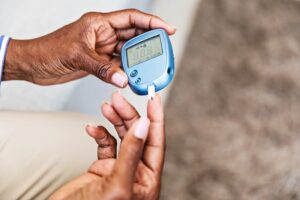 Woman with diabetes checking her blood sugar.
